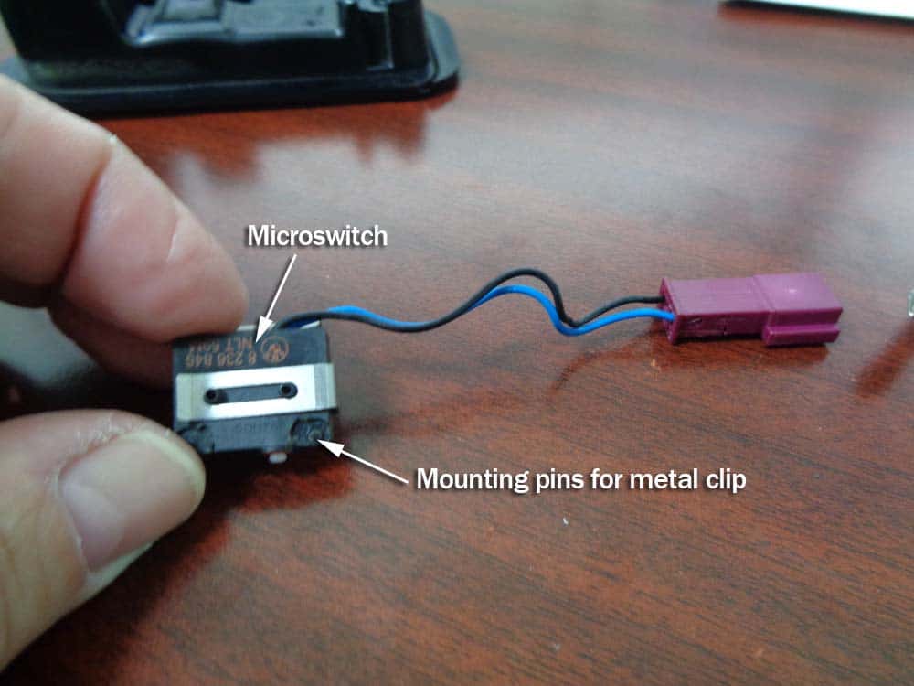 BMW E85 convertible microswitch repair - Locate the mounting pins on the side of the switch