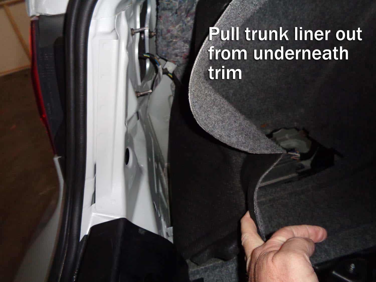 Pull back the trunk liner to expose the amplifier