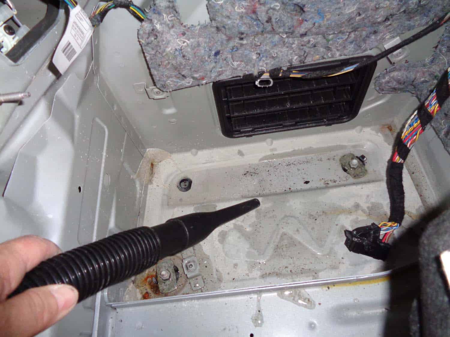 Vacuum out any standing water in the trunk
