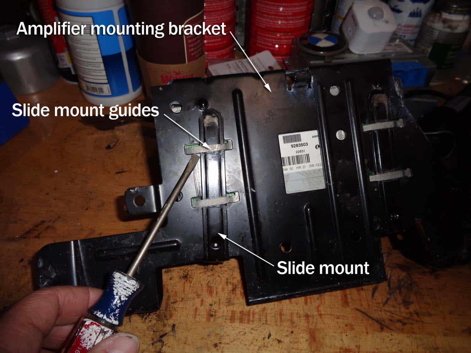 bmw e90 amplifier water damage repair - remove the locking brackets from amplifier