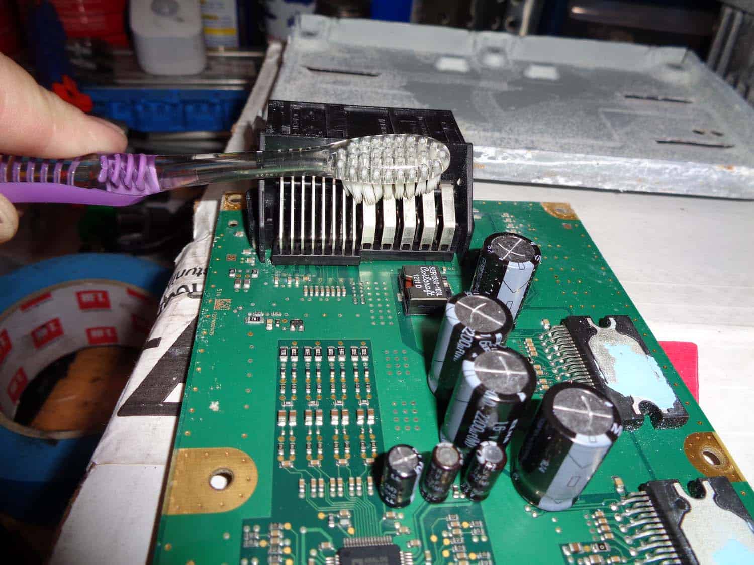 bmw e90 amplifier water damage repair - carefully clean the circuit board with toothbrush