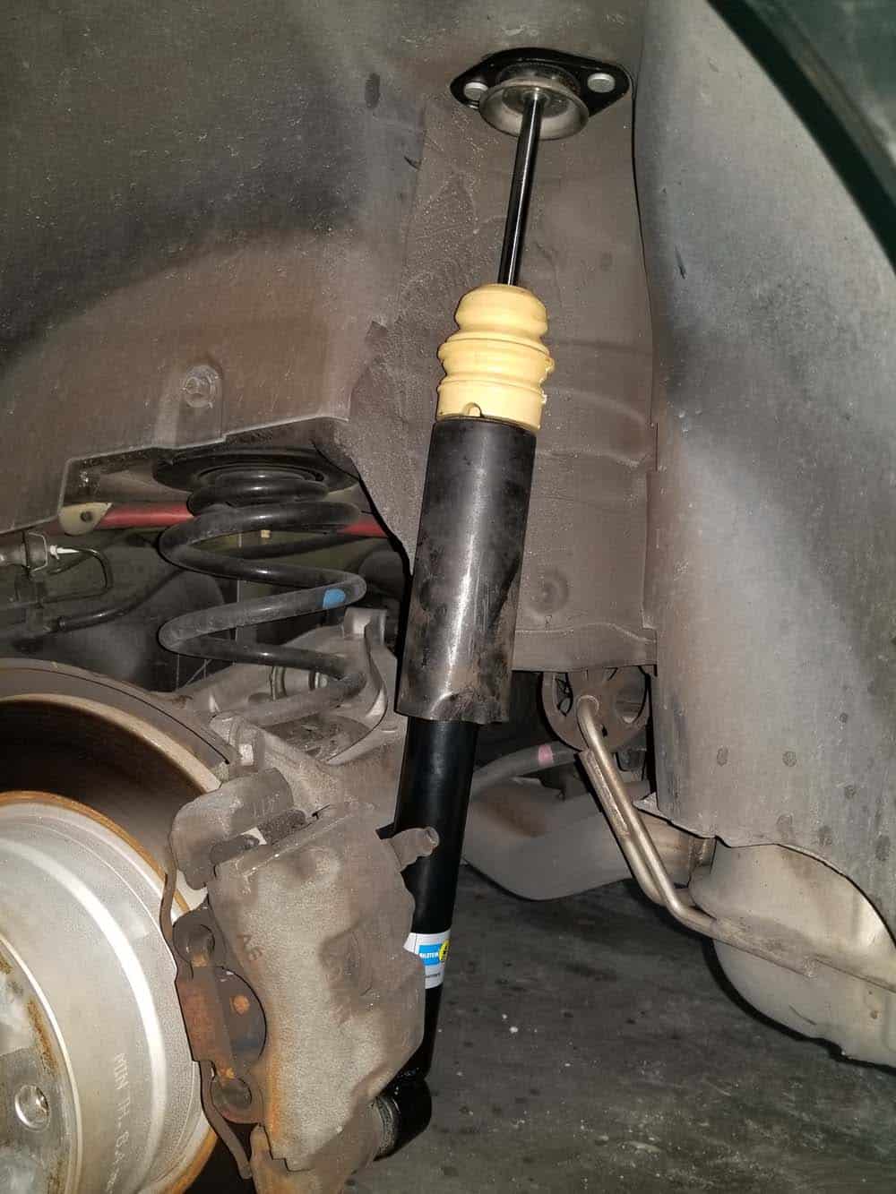 Install the new shock back in the vehicle.