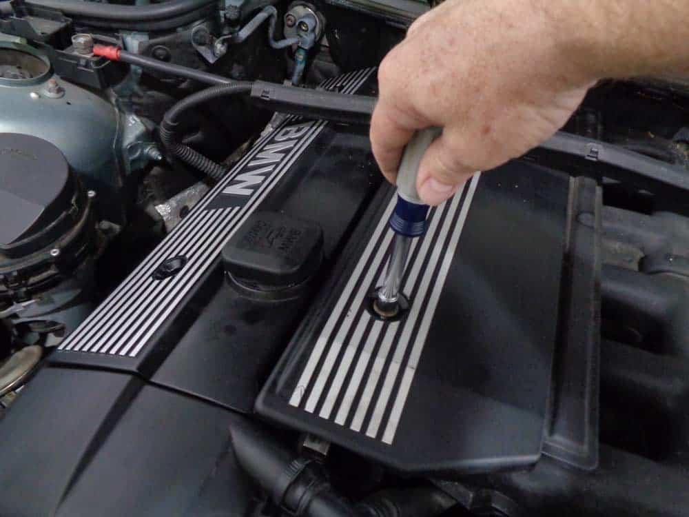 bmw fuel pressure test - Use a 10mm socket wrench to remove the engine cover mounting bolts