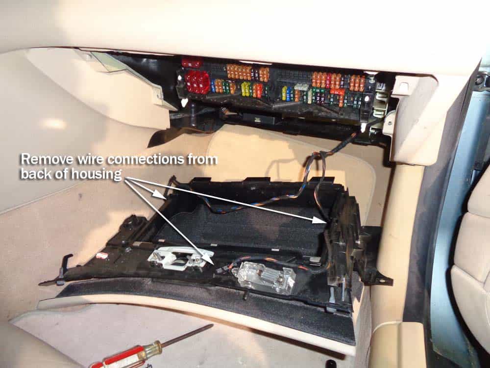 Remove the wiring connections from the back of the glove box housing