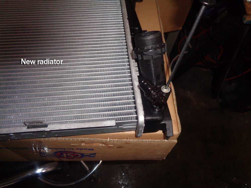 BMW E90 radiator - install the plastic hose mount on new radiator