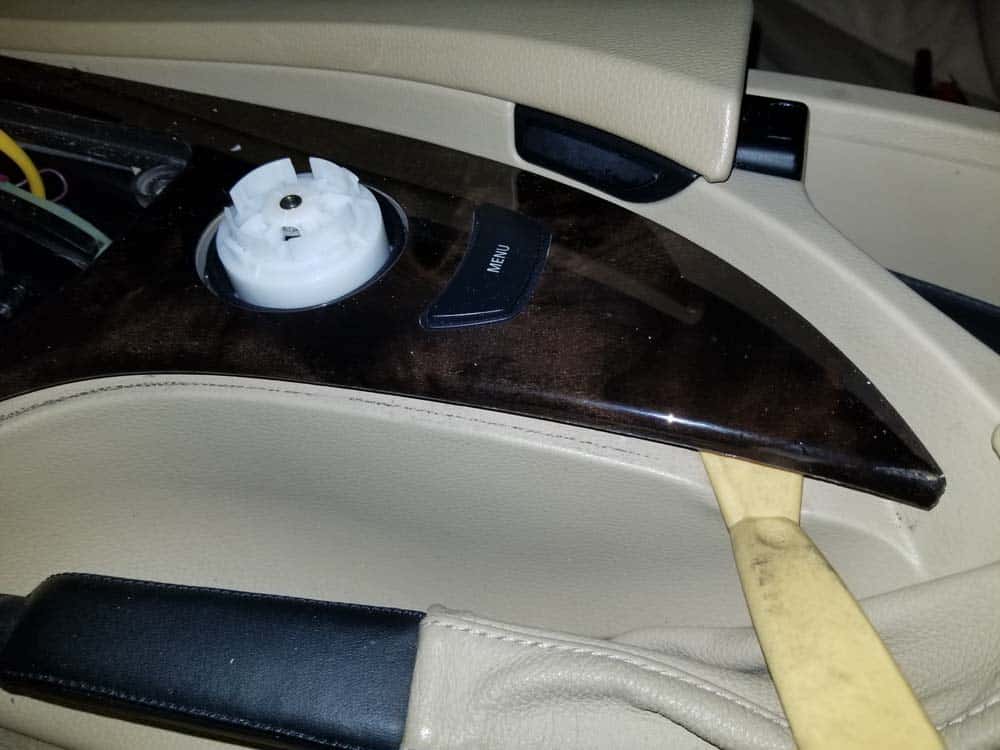 Pry up the back of the center console trim with a plastic trim tool.
