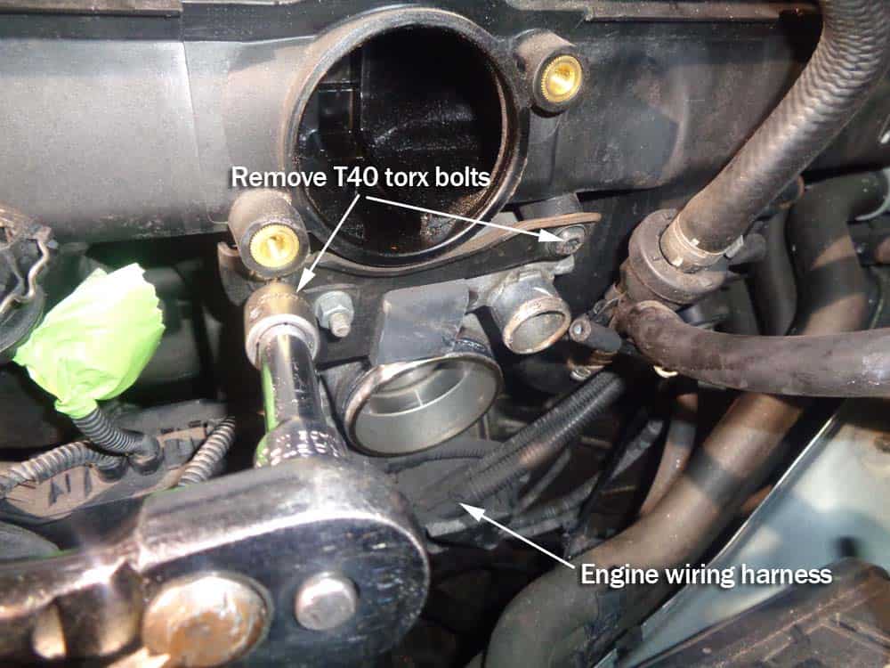 BMW e46 rough idle repair - Remove the two T40 torx bolts anchoring the wiring harness to the intake manifold.