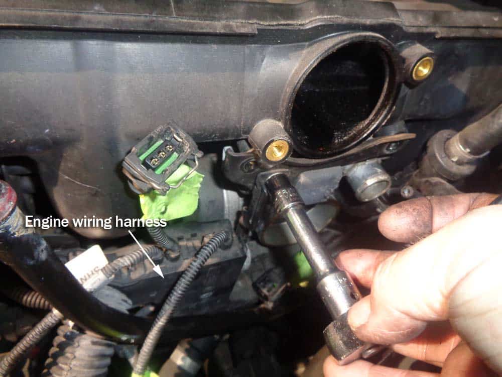 BMW e46 rough idle repair - Remove the upper 10mm wiring harness mounting bolt