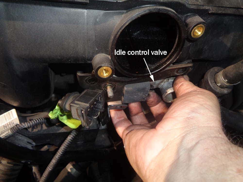 BMW e46 rough idle repair - Grasp the idle control valve and pull it free from the intake manifold