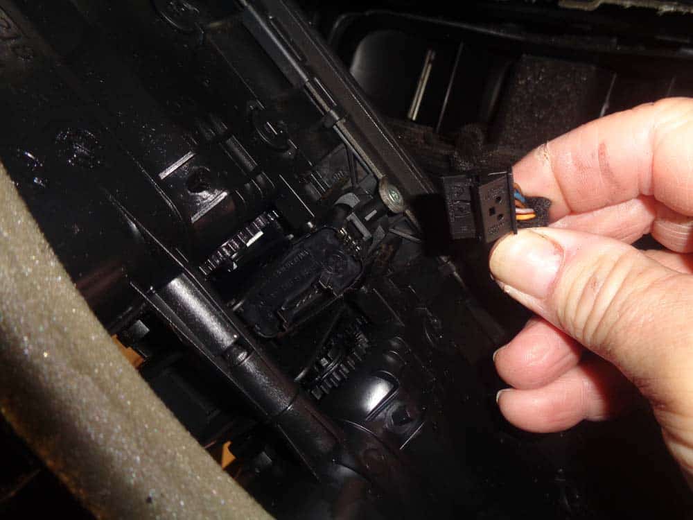 bmw auxiliary port - pull the plug free from the door lock switch