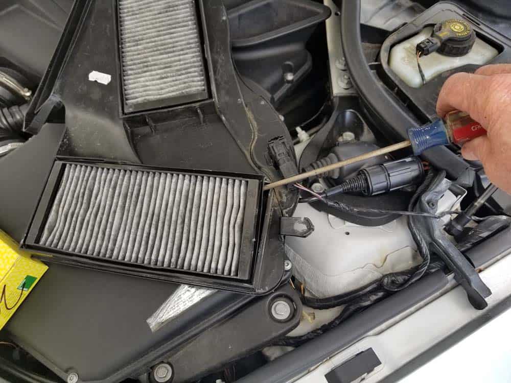 Use a flay blade screwdriver to remove the cabin filters from the cover