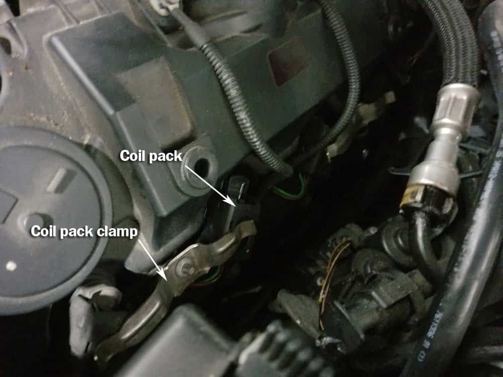 BMW N62 engine tune up - Remove the four ignition coil clamps.