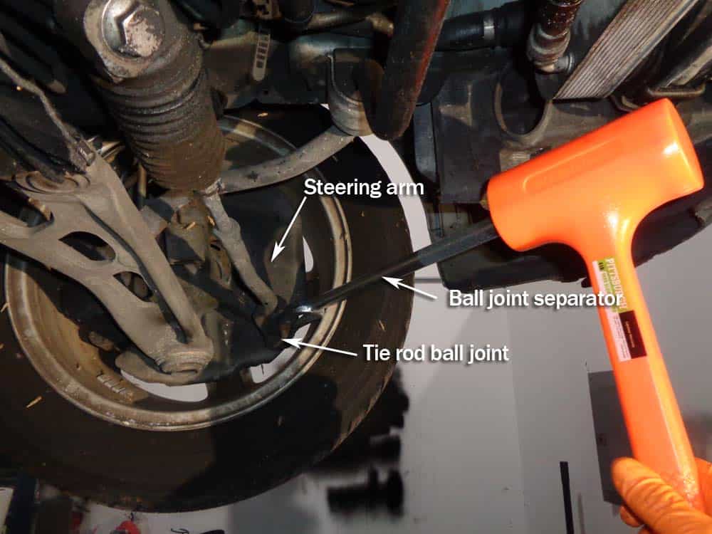BMW E46 Tie Rod Repair - Use a hammer to remove the ball joint from the steering arm