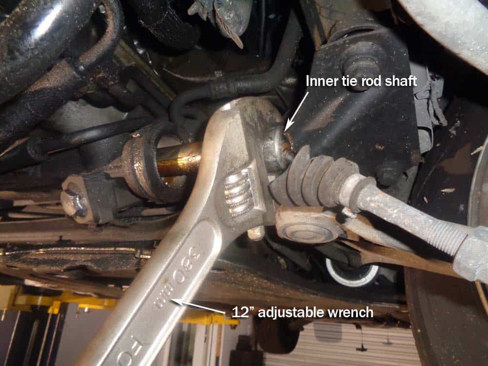 Use an adjustable wrench to loosen the inner tie rod shaft