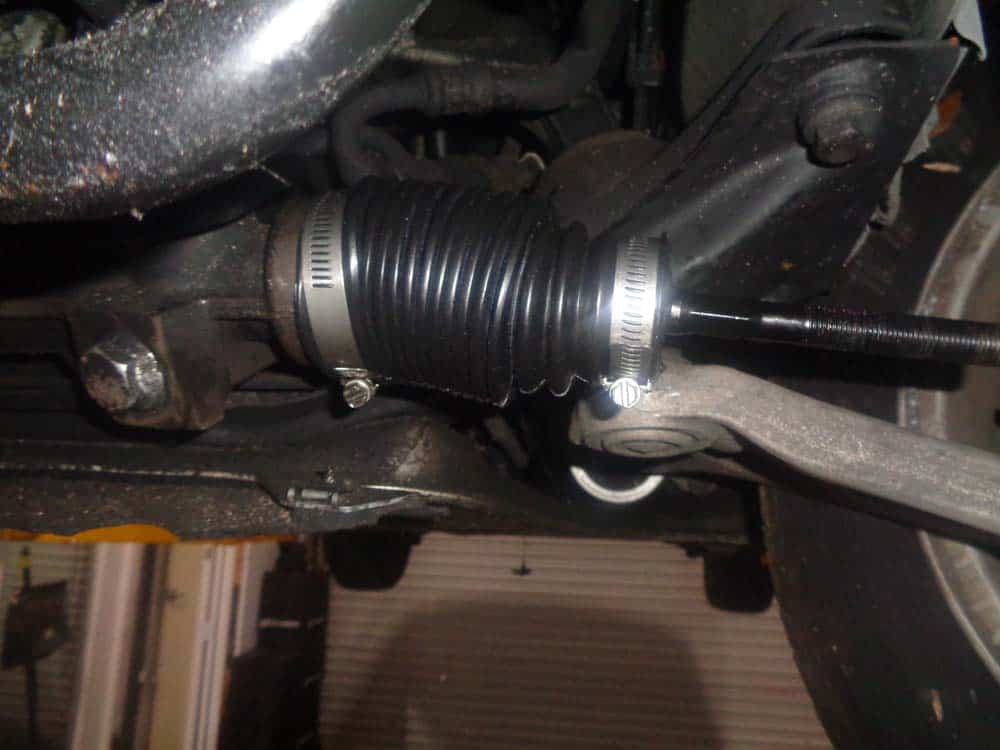 Slide the steering boot onto the inner tie rod and tighten the clamps.