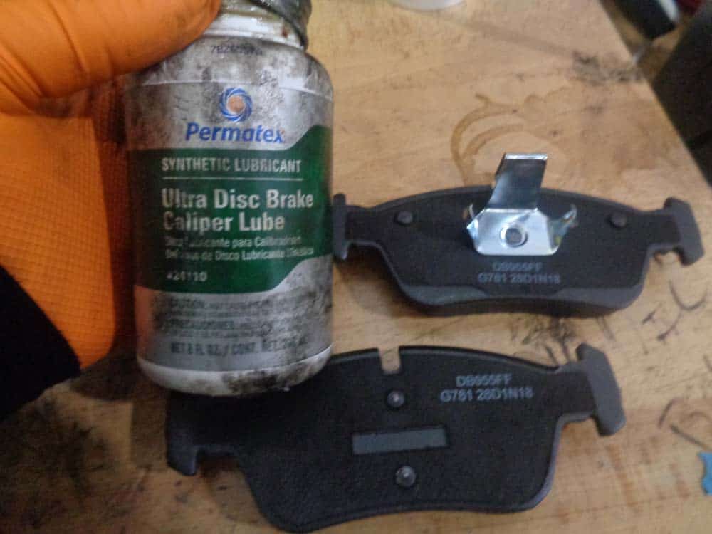 BMW E36 brake repair - apply caliper lubricant to the back of the brake pads