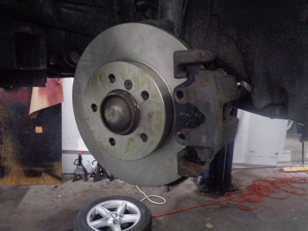 BMW E46 brake repair -install the caliper back on the rotor.
