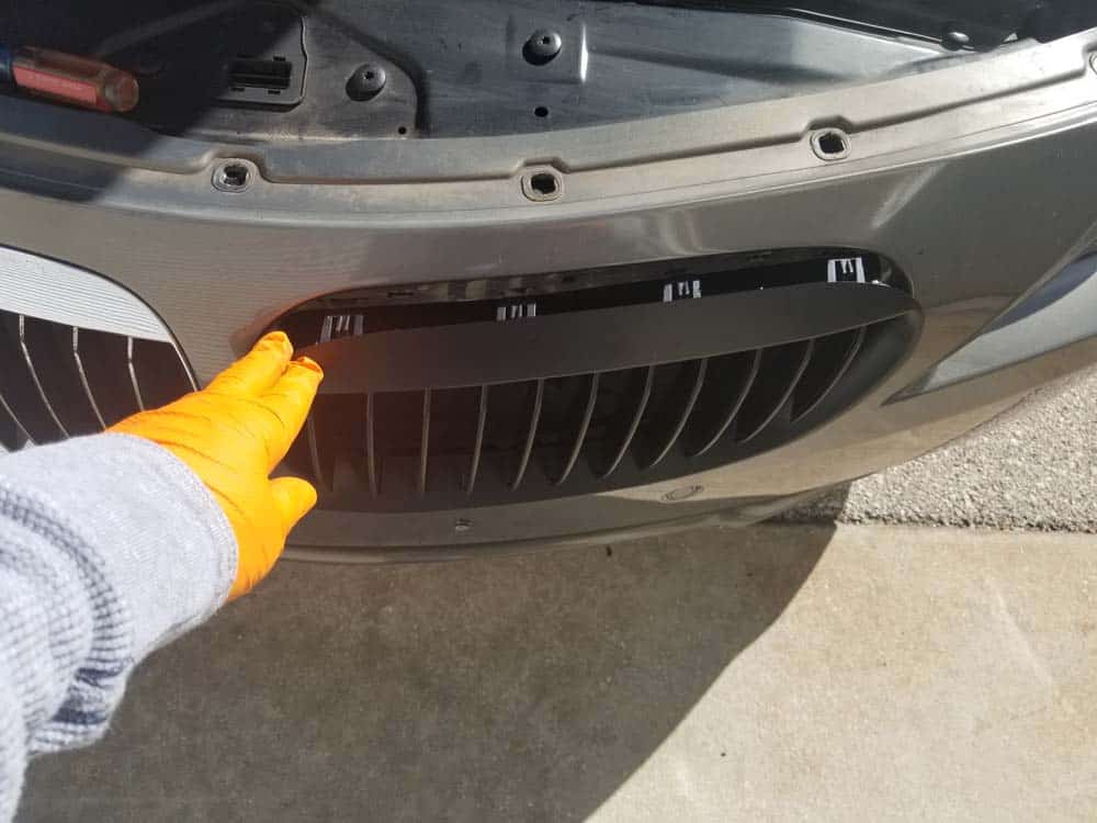 Line up the new grille in the bumper opening