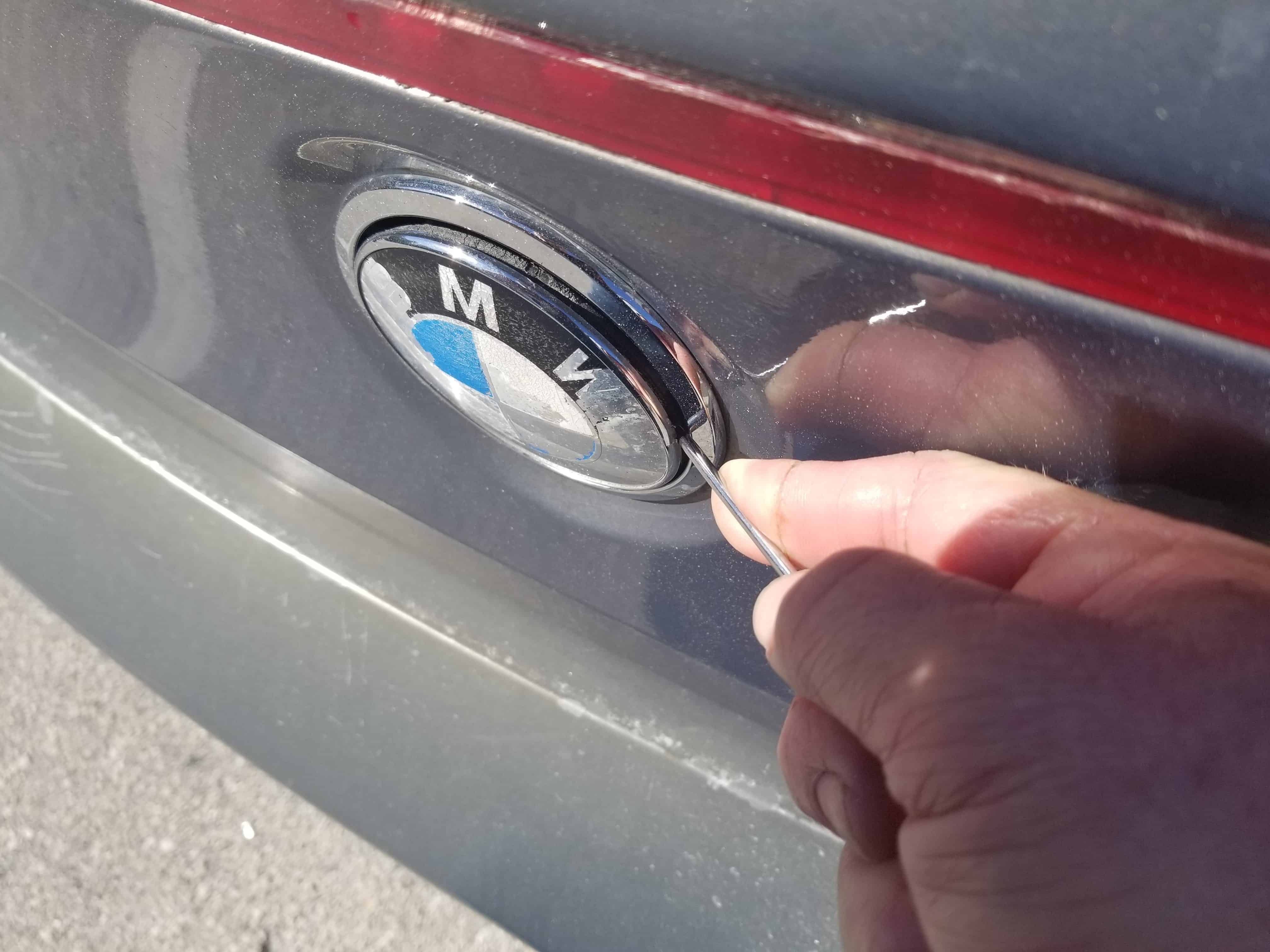 BMW 645ci emblem replacement - Use a metal pick to pry the emblem free