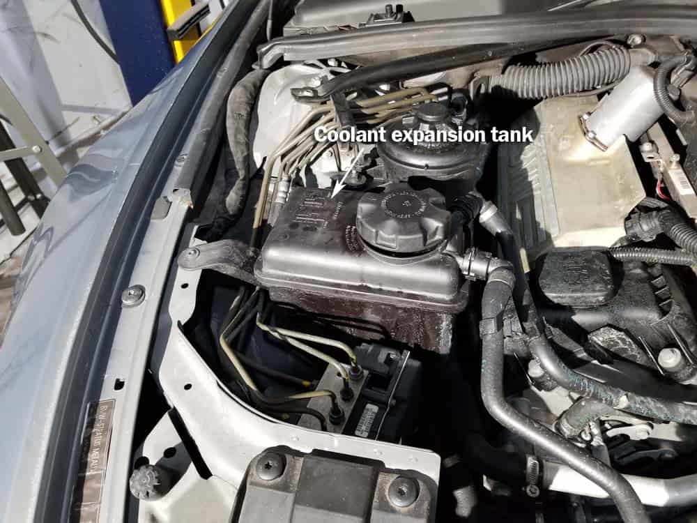 bmw coolant expansion tank replacement - Identify the coolant expansion tank on the right side of the engine.