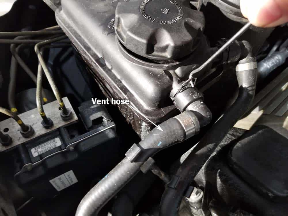 bmw coolant expansion tank replacement - Remove the vent hose from the coolant reservoir.
