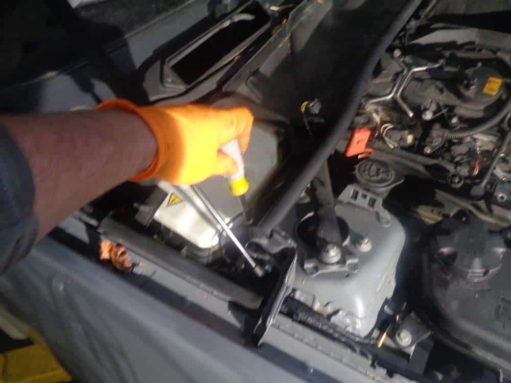 Use an 8mm socket wrench or nut driver to remove the screws anchoring the lower cabin filter housing