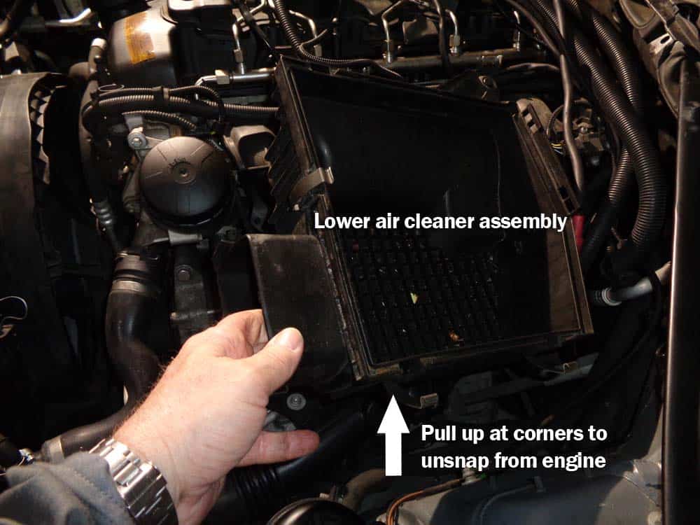 Pull up on the corners to unsnap the air cleaner assembly.