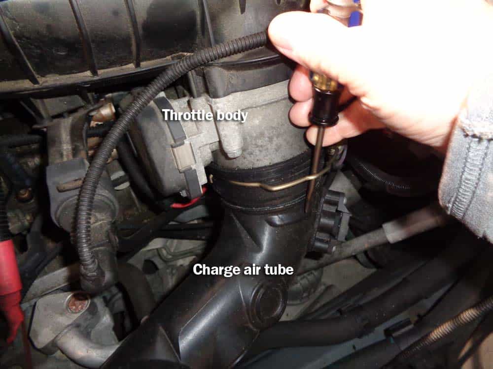 Unsnap the locking ring that connects the turbo charge air tube to the throttle body with flat blade screwdriver. Loosen hose clamp and remove T30 torx bolt anchoring tube to engine. Remove tube (a flat blade screwdriver helps remove from throttle body).