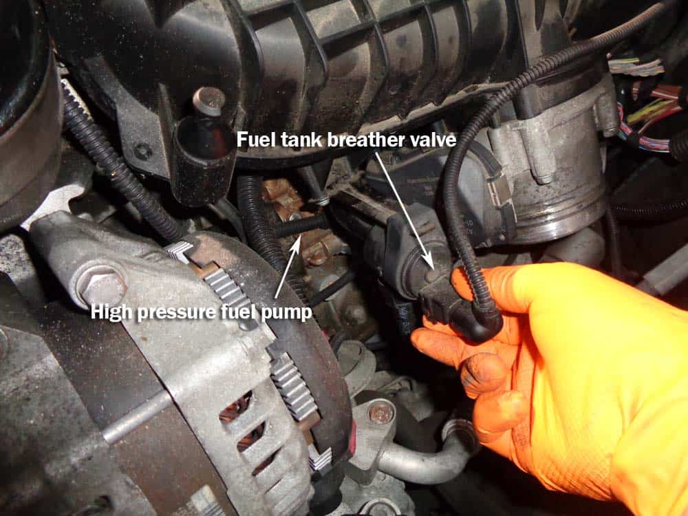 bmw high pressure fuel pump - Grasp the electrical connection to the fuel tank vent valve and squeeze.