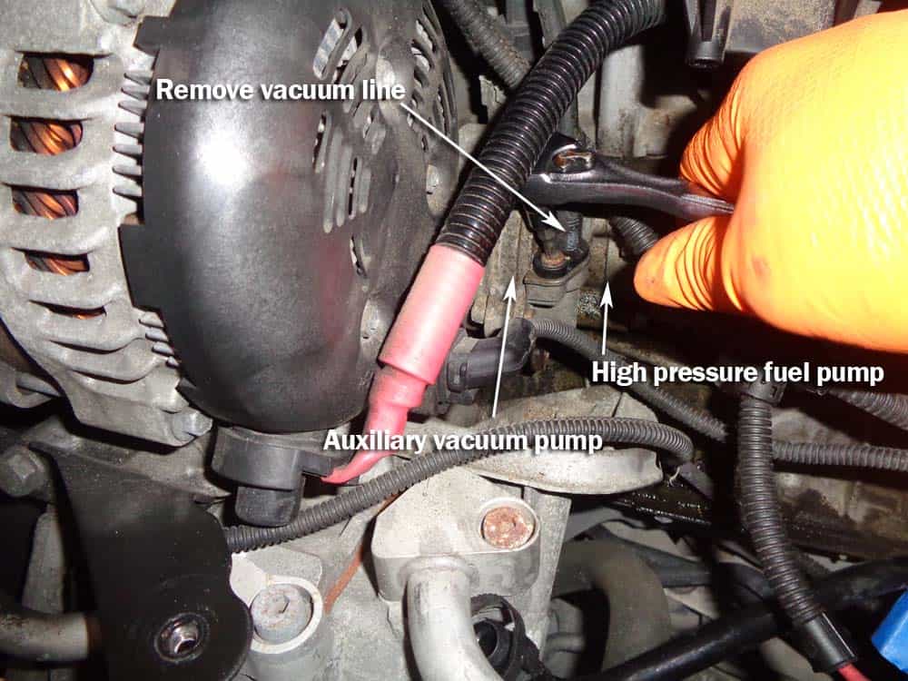Use an E25 external torx socket to remove the vacuum line from the auxiliary pump.