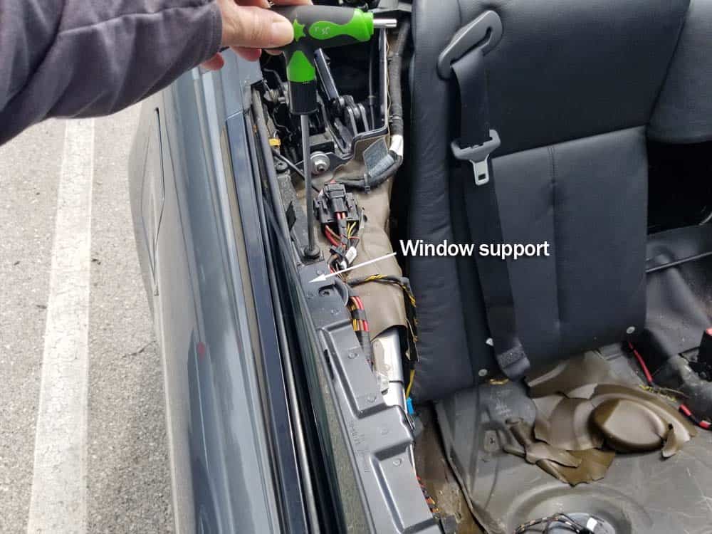 BMW E64 Rear Window Regulator - remove the T30 torx bolt anchoring the rear window support