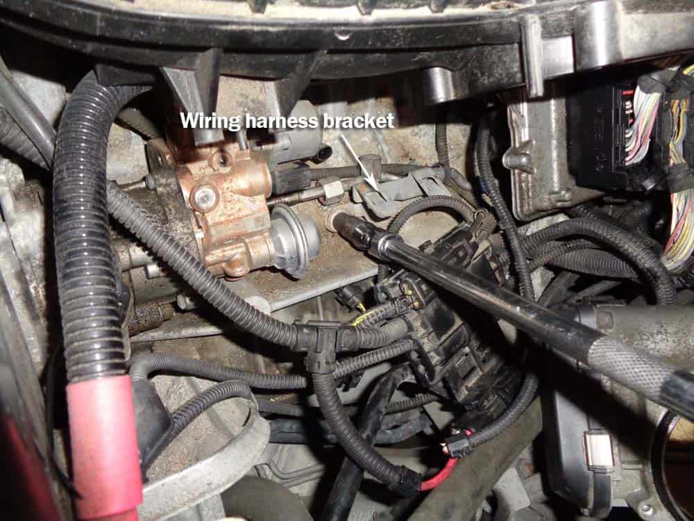 bmw high pressure fuel pump - Remove the wiring harness bracket next to fuel pump.