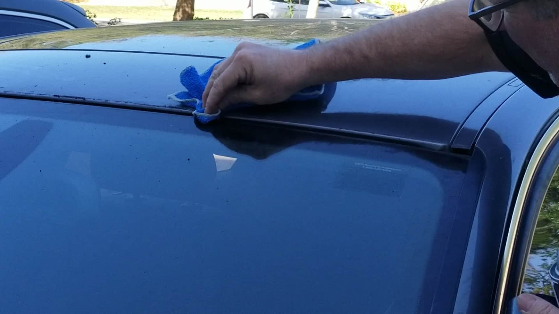 bmw windshield moulding replacement - Use a rag soaked in adhesive remover to wipe down the roof and the windshield.