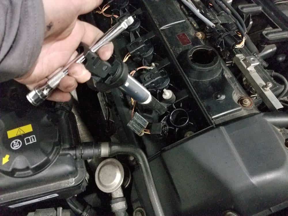 BMW E60 Tune Up - Use a socket extension to help pull the coil from the spark plug tube