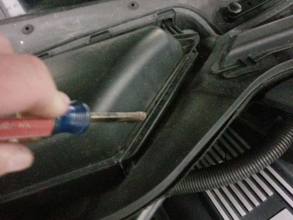 BMW E60 Tune Up - Remove the metal retaining clip on the cabin filter container