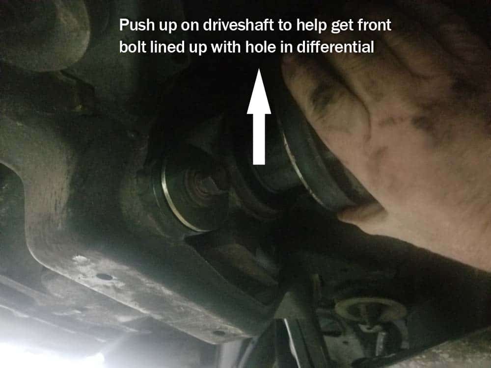 push up on driveshaft to get front bolt lined up with hole