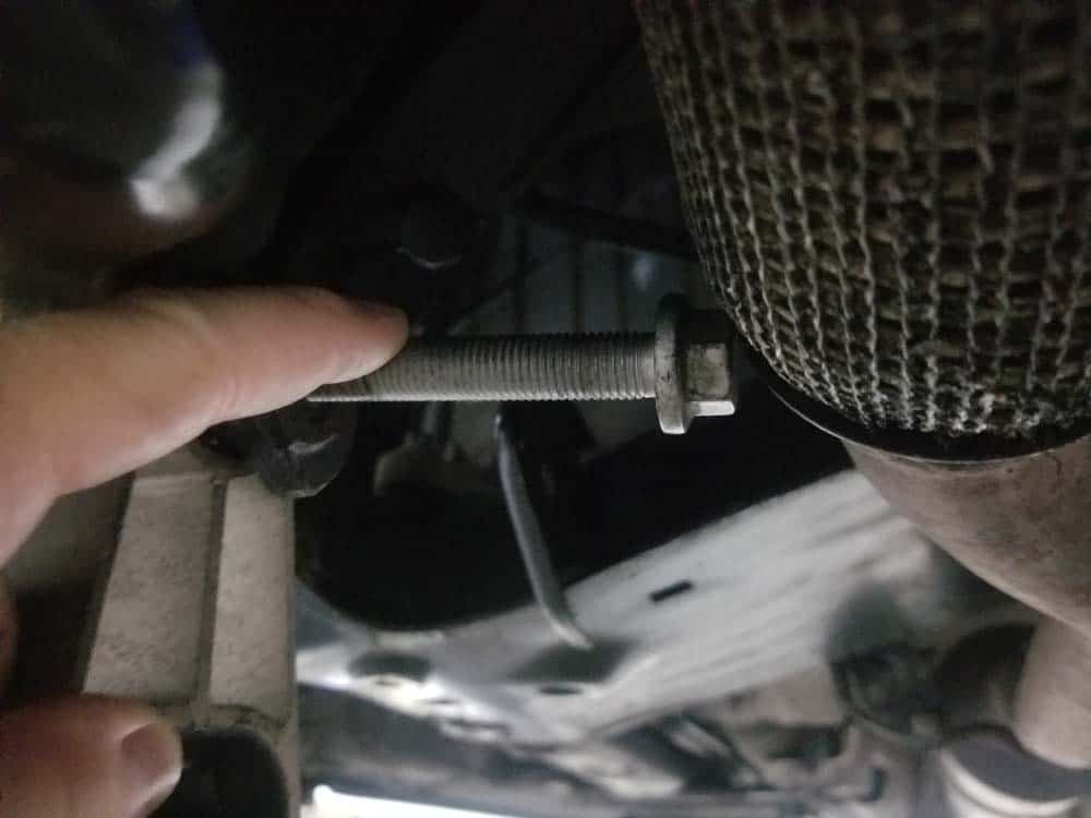 Removing front bolt can be difficult because of the exhaust pipe