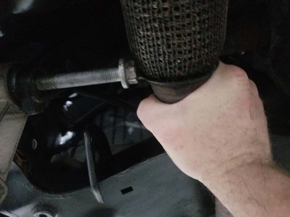 Push the exhaust pipe up with your hand to get clearance for the bolt