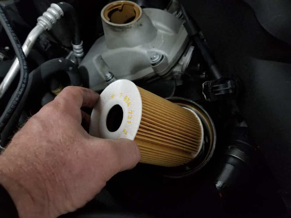 Install a new oil filter into housing