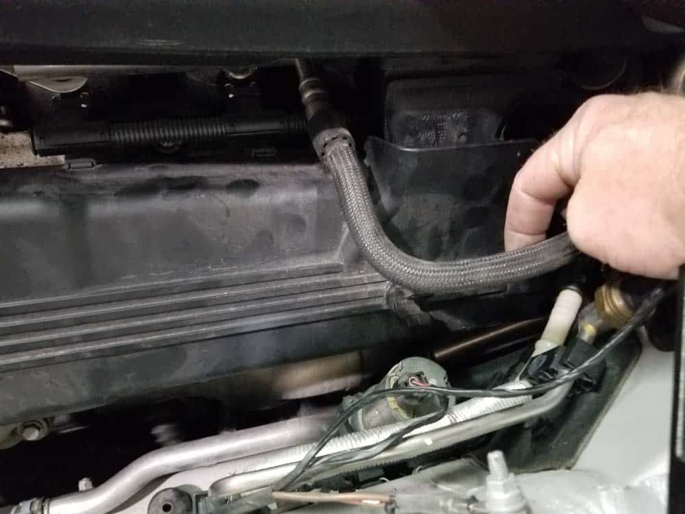 BMW E90 M3 tune up - pull the fuel line loose from the left engine cover