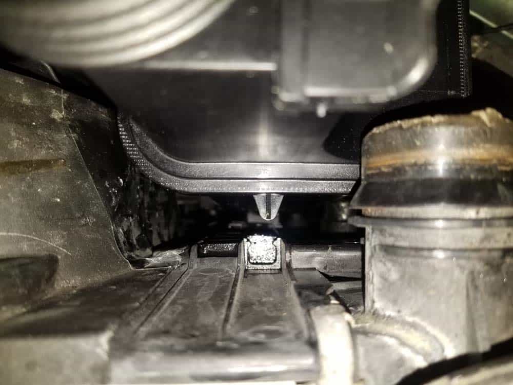 Make sure to guide the tab on the back of the tank into the groove in radiator.