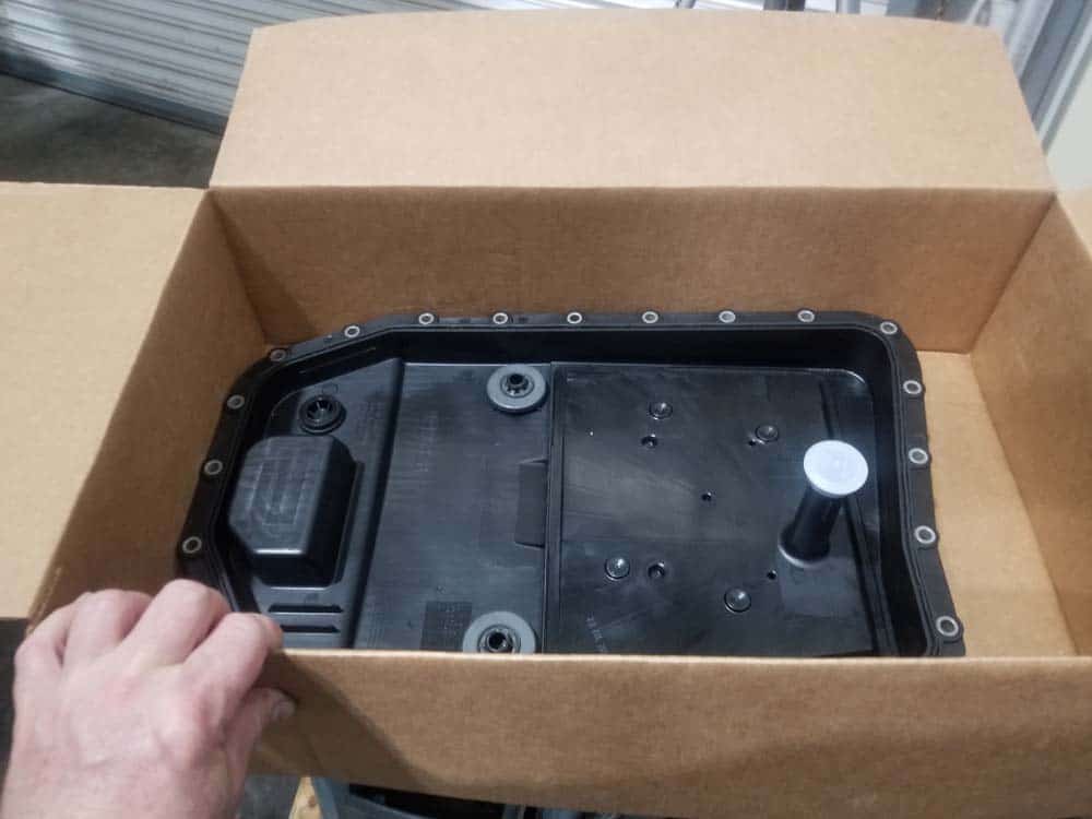 BMW E60 transmission service - Unpack the new oil pan and verify part number