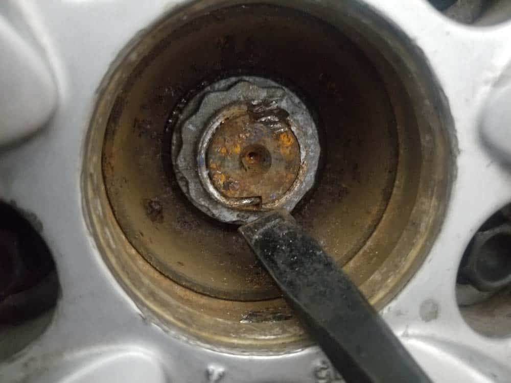 bmw e60 front axle shaft - Use a chisel or steel punch to try and straighten or break off the locking clips on the axle nut.
