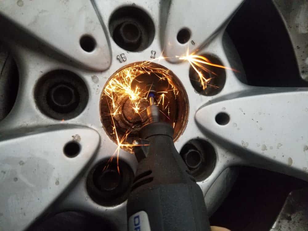 Cutting the axle nut locking clips off with a Dremel too.