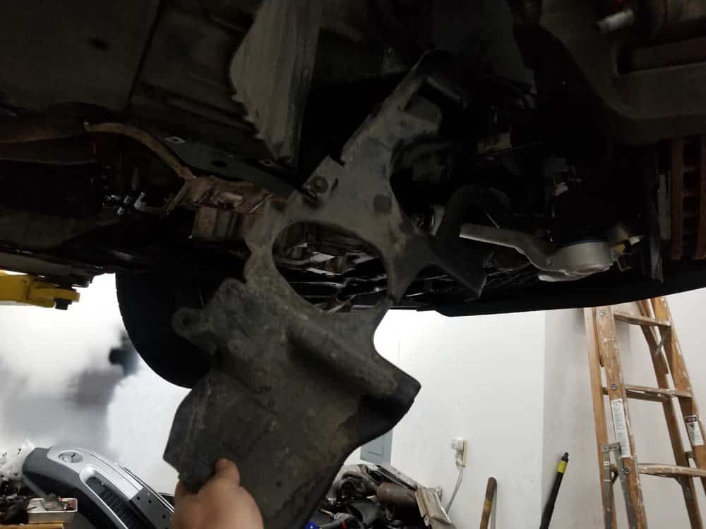 bmw e60 front axle shaft - Remove the splash guard from the vehicle.