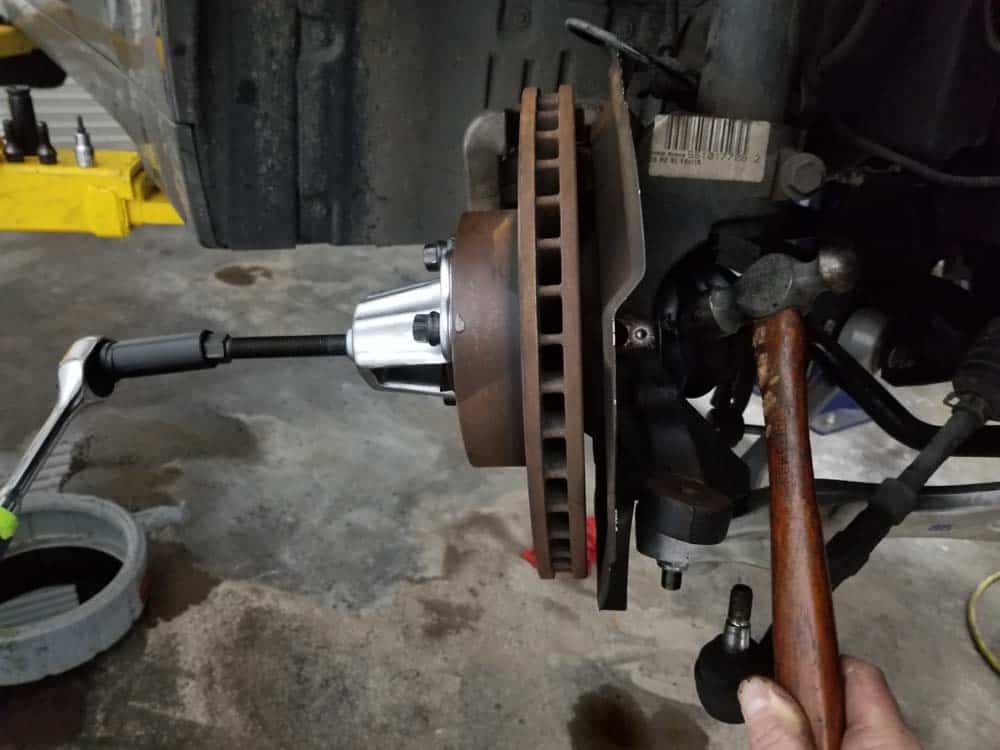 bmw e60 front axle shaft - Strike the axle several times with a hammer to get it to release from the hub.