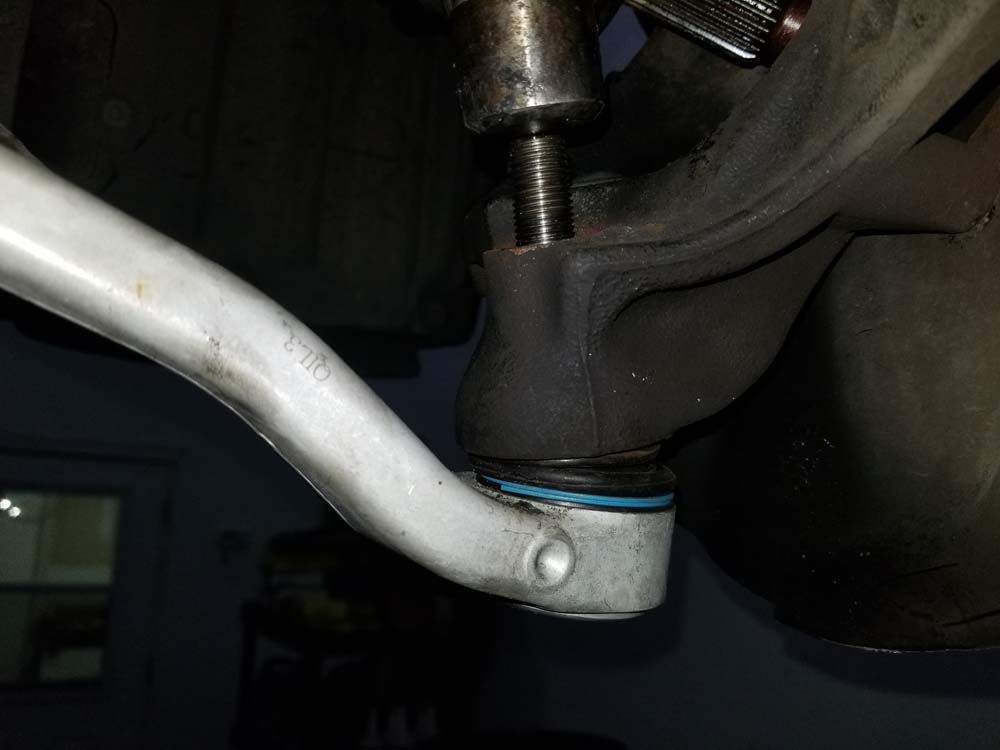 Use a hammer to knock the lower control arm ball joint out of the steering knuckle.