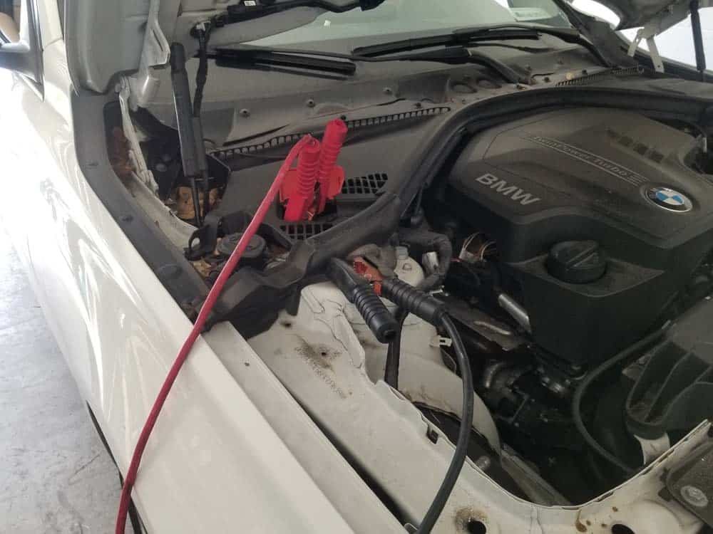 BMW F30 battery replacement - If the battery is completely dead, jump or connect a charger using the positive terminal and ground in the engine compartment.