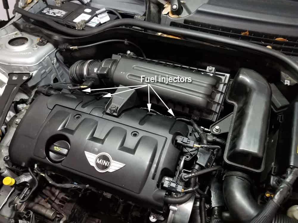MINI R56 fuel injectors - Locate the engine fuel injectors located on fuel rail behind valve cover.