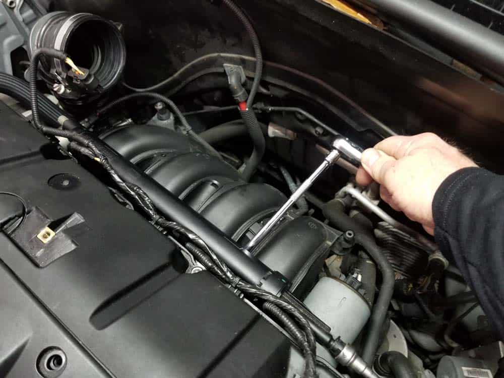 MINI R56 water pipe replacement - Remove the two torx bolts anchoring the fuel rail to the engine.